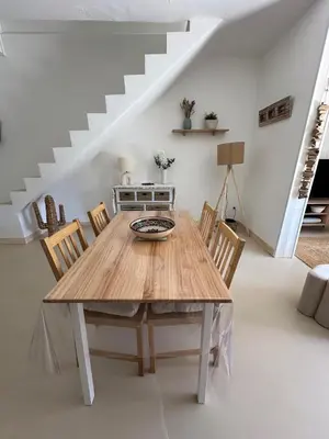 a dining room with a wooden table and chairs at La Villa des Sables Borgu in Borgo