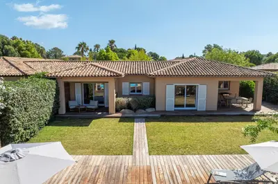 a villa with a garden and a house at Villa Rossa in Lecci