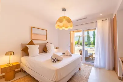 a bedroom with a bed with a laptop on it at Villa Rossa in Lecci
