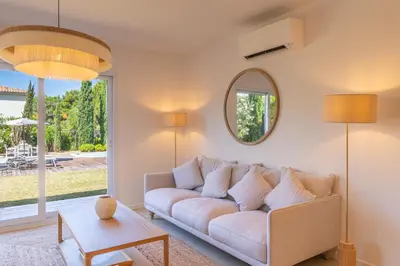 a living room with a white couch and a mirror at Villa Rossa in Lecci