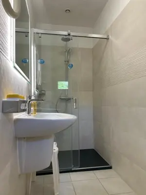 a bathroom with a sink and a shower at Hôtel Punta e Mare des Chambres ou des Appartements T2 in Cargèse