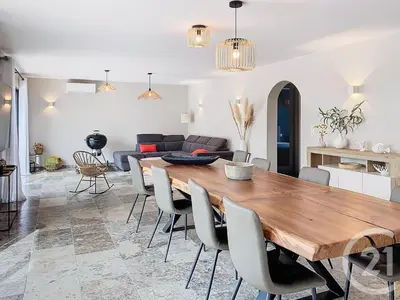 a living room with a wooden table and chairs at Villa de standing, proche des plages et au calme in Lecci