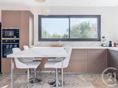 a kitchen with a white table and chairs and a window at Villa de standing, proche des plages et au calme in Lecci
