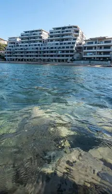 a view of the water in front of some buildings at propriano pieds dans l eau in Propriano