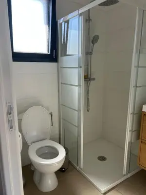 a bathroom with a toilet and a shower at Le cocon de Malo in Lecci