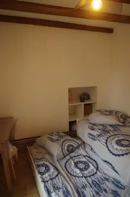a room with two beds in a room at Typical Corsican apartment in Cervione