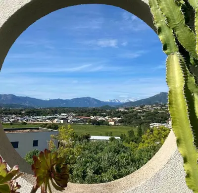 a view of a beach with a town in the background at Apartment with terrace close to the beach in Grosseto-Prugna
