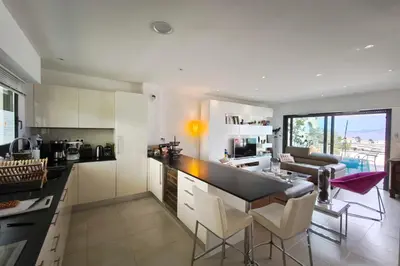 a dining room and living room with a table and chairs at Apartment with terrace close to the beach in Grosseto-Prugna