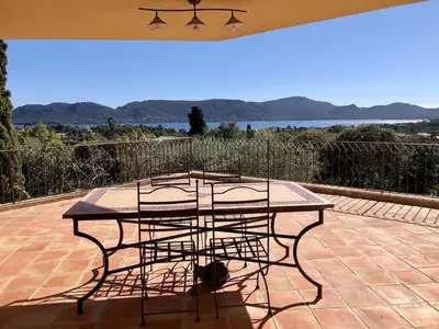 a table and chairs sitting on a patio at CASA 'LLU PILOTA - Grand appartement dans villa plein sud vue mer - Large apartment in a south-facing villa with sea view in Porto-Vecchio