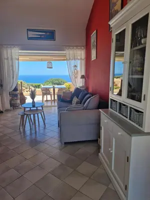 a living room with a couch and a table at Les Terrasses du Levant in Porto-Vecchio