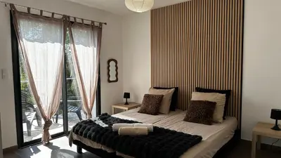 a bedroom with a bed and a large window at Domaine LOADANA in Sainte-Lucie de Porto-Vecchio