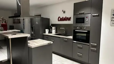 a kitchen with stainless steel appliances in a room at Domaine LOADANA in Sainte-Lucie de Porto-Vecchio
