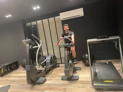 a man sitting on a treadmill in a gym at Villa Clémentines Porticcio in Grosseto-Prugna