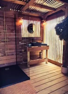 a bathroom with a sink on a wooden deck at Glamping luxe entre mer et maquis in Ajaccio