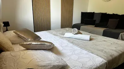 a hotel room with two beds with a pillow on it at Villa Amacali vue mer piscine chauffée climatisée in Sainte-Lucie de Porto-Vecchio