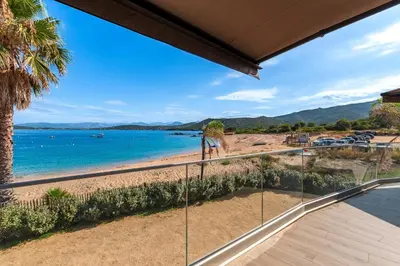 a view of the beach from the balcony of a house at Le Roc - 1er étage - Splendide Vue Mer in Coti-Chiavari