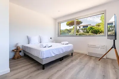 a bedroom with a bed and a window at Le Roc - 1er étage - Splendide Vue Mer in Coti-Chiavari