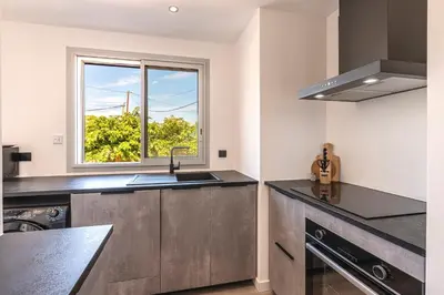 a kitchen with a sink and a window at Le Roc - 1er étage - Splendide Vue Mer in Coti-Chiavari