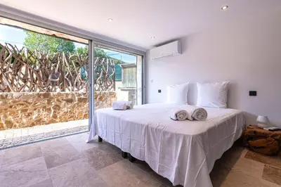 a bedroom with a bed with two towels on it at Le Roc - RDC - Splendide Vue Mer in Coti-Chiavari