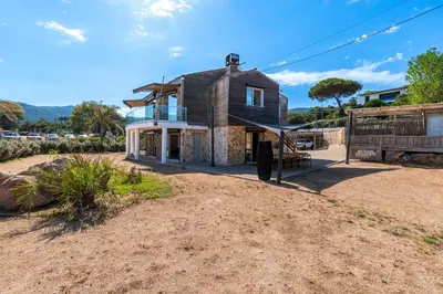 a house on the side of a dirt road at Le Roc - RDC - Splendide Vue Mer in Coti-Chiavari