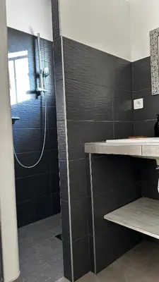 a bathroom with a shower and a sink at Villa Serenita vue mer in Sainte-Lucie de Porto-Vecchio