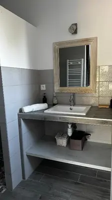 a bathroom with a sink and a mirror at Villa Serenita vue mer in Sainte-Lucie de Porto-Vecchio