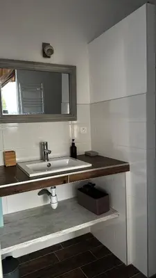 a bathroom with a sink and a mirror at Villa Serenita vue mer in Sainte-Lucie de Porto-Vecchio