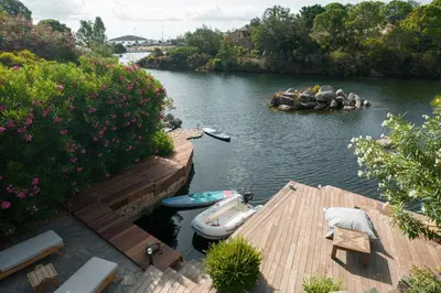 a dock with two boats on a river at Villa Sempietru, 8 pers, lagon & plage à pied in Lecci