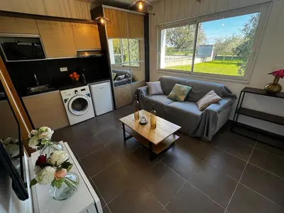 a living room with a couch and a table at Maison à 2 minutes de la mer en voiture in Sorbo-Ocagnano