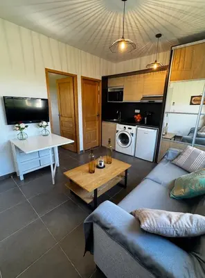 a living room with a couch and a table at Maison à 2 minutes de la mer en voiture in Sorbo-Ocagnano