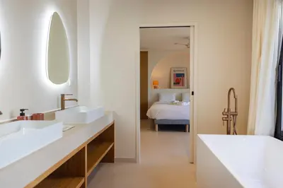 a bathroom with two sinks and a bedroom with a bed at Balamb Garden A Rinascita in Ajaccio