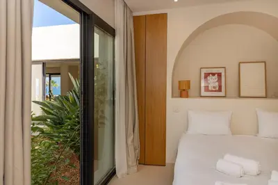 a bedroom with a bed and a large window at Balamb Garden A Rinascita in Ajaccio