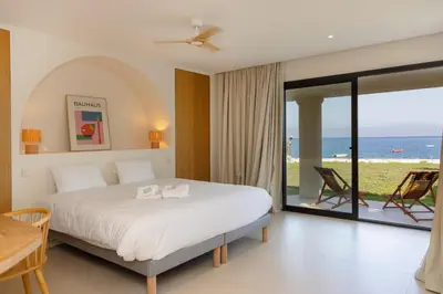 a bedroom with a bed and a view of the ocean at Balamb Garden A Rinascita in Ajaccio