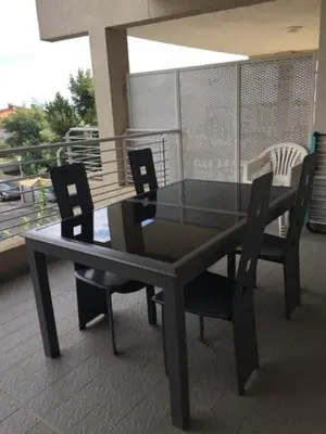 a black dining room table and chairs on a balcony at CORSE RESIDENCE COSTA D'ORO Folelli F2 in Penta-di-Casinca