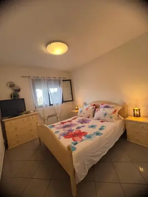 a bedroom with a bed and a television in it at CORSE RESIDENCE COSTA D'ORO Folelli F2 in Penta-di-Casinca