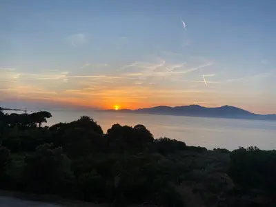 a view of the sun setting over the water at Pietrosella Bord de Mer in Pietrosella