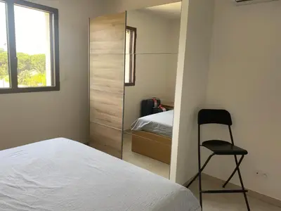 a bedroom with a bed and a chair in it at Pietrosella Bord de Mer in Pietrosella