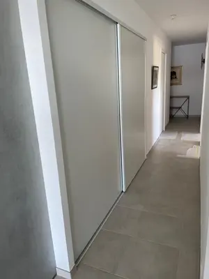 a hallway with sliding glass doors in a house at Pietrosella Bord de Mer in Pietrosella