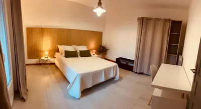 a hotel room with a bed and a window at La parenthèse in Lucciana