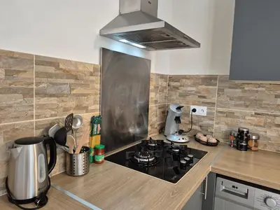 a kitchen with a stove top oven in a kitchen at La parenthèse in Lucciana