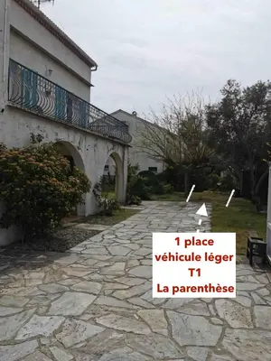 a building with a sign that reads i place vehicle ledger la parasi at La parenthèse in Lucciana