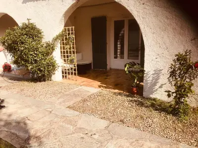 an entrance to a house with plants and a door at La parenthèse in Lucciana