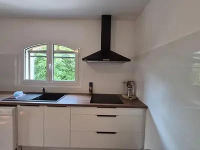 a kitchen with a sink and a window in it at Chez nous in Lucciana