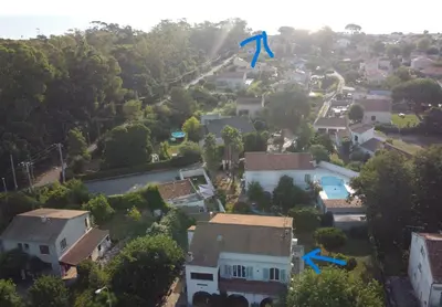 a blue kite flying over a residential neighborhood at Chez nous in Lucciana