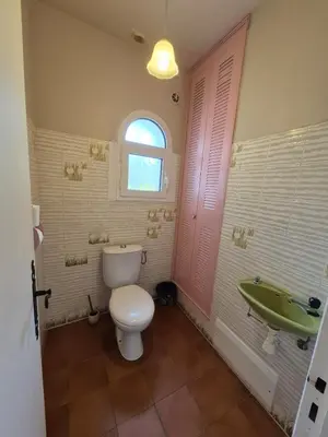 a bathroom with a toilet and a sink and a tub at Chez nous in Lucciana