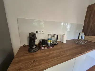 a counter top with a blender and glasses on it at Chez nous in Lucciana