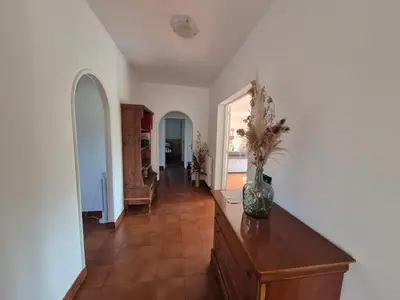 a living room with a vase on a wooden dresser at Chez nous in Lucciana