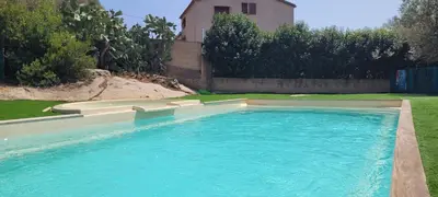 a swimming pool in the yard of a house at T2 Port de Porto Vecchio 4 pers vue Montagne in Porto-Vecchio