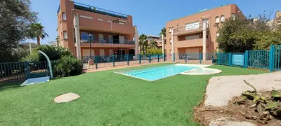 a yard with a swimming pool in front of a building at T2 Port de Porto Vecchio 4 pers vue Montagne in Porto-Vecchio