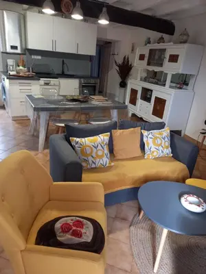 a living room with two couches and a kitchen at Appartement Casa Rose in Sollacaro